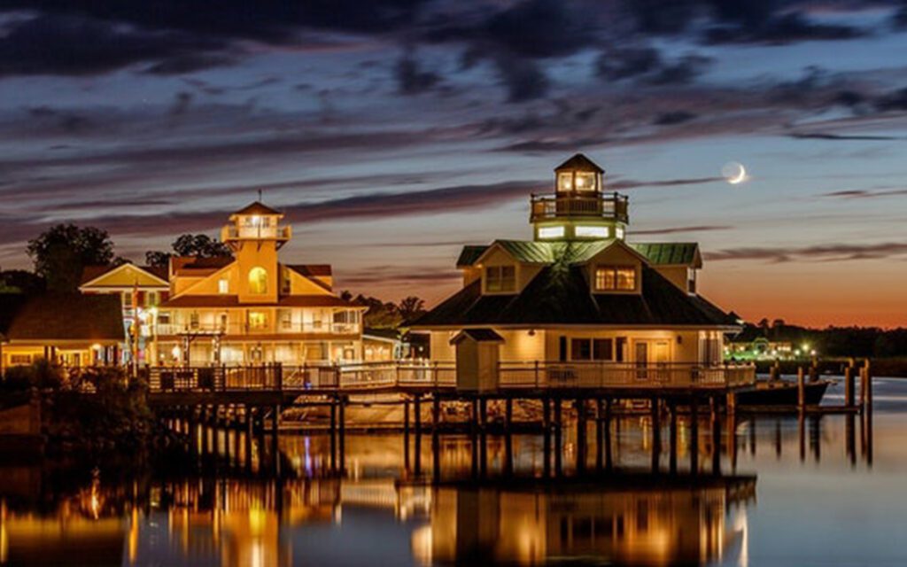 Homepage - Aerial View of Smithfield Station at Night With Lights Reflecting into the Water